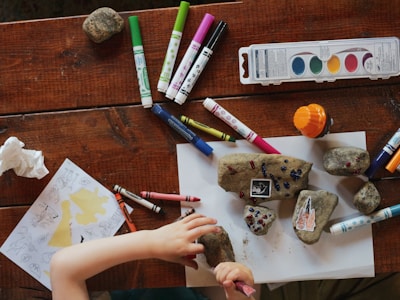 Child painting with bright colours